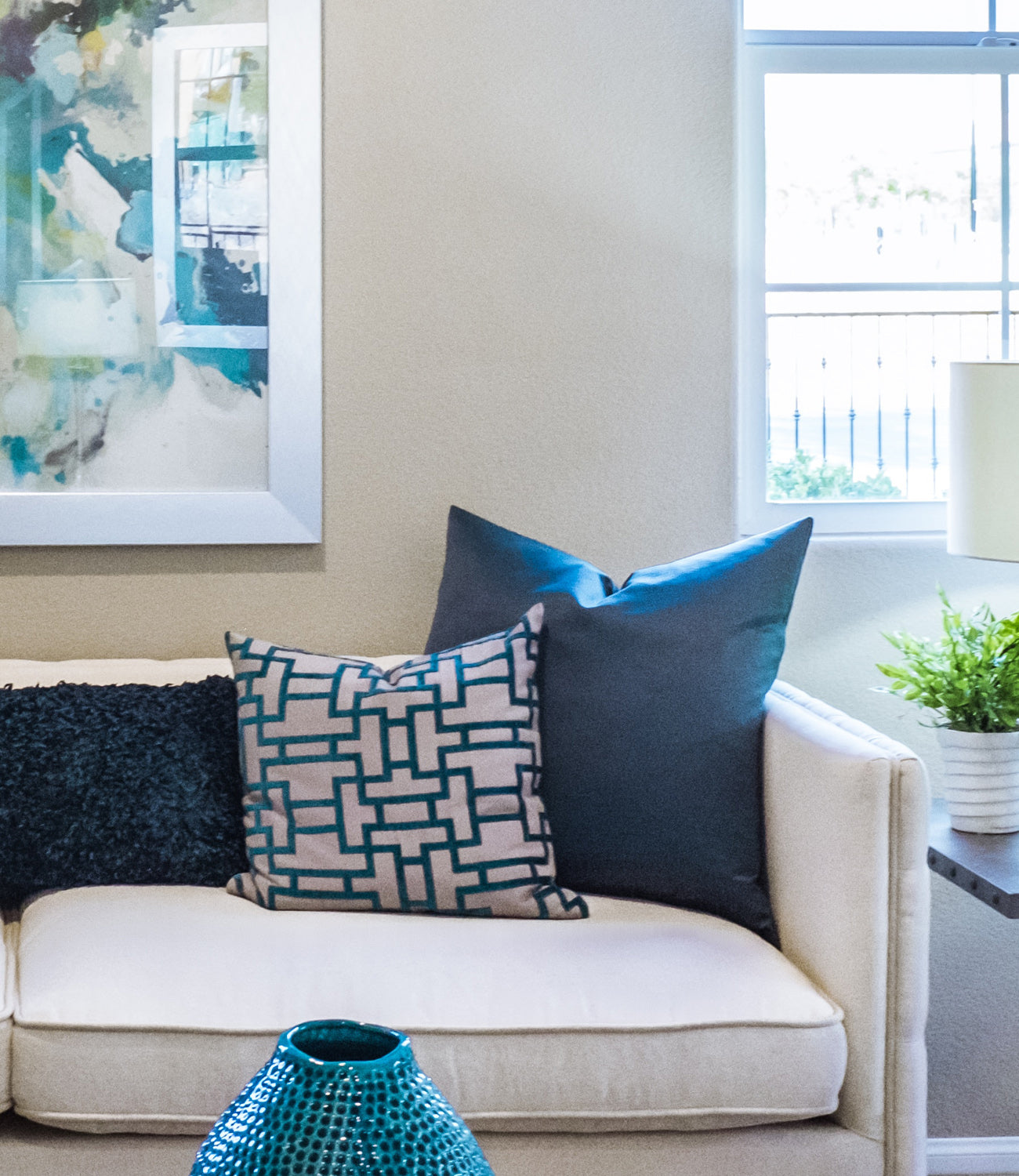 blue pillow cover on a beige sofa